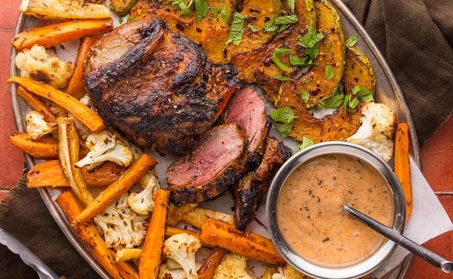 Herb-Roasted Leg of Lamb with Butter-Baked Potatoes and Slow-Roasted Tomatoes