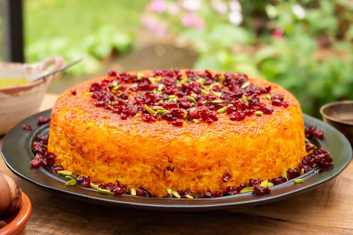 Saffron-Crusted Persian Tahchin with Chicken, Spinach, and Dried Plums